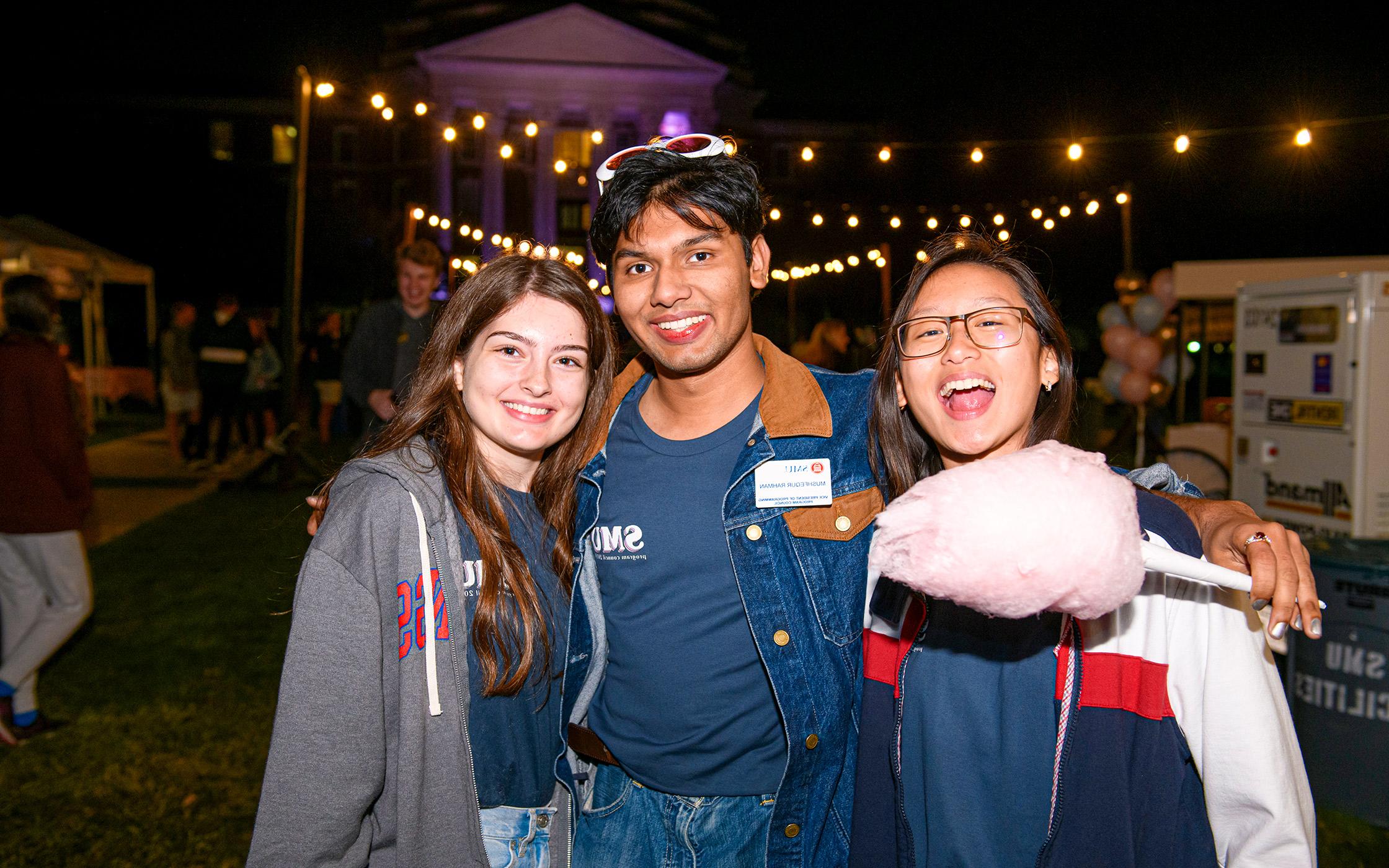 Three SMU students at Midnight Market event